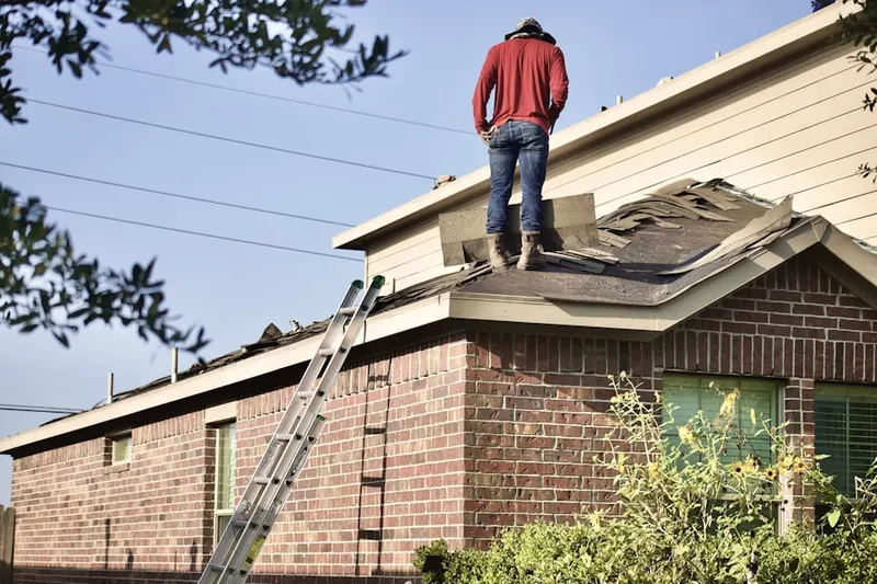 Professional roofer working on a residential roof in Maumee